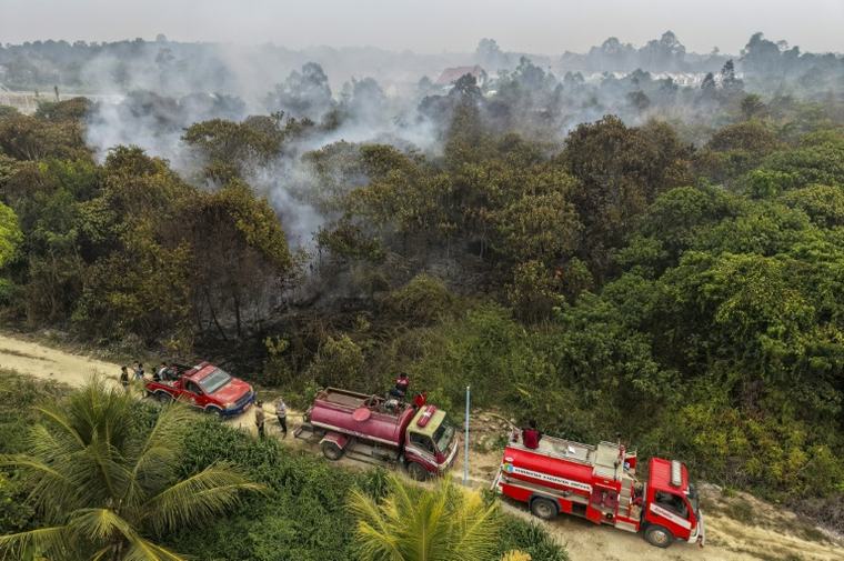 Shrouding communities in cloying haze: 'Truly scared': Blazes outpace firefighters in Indonesian Borneo